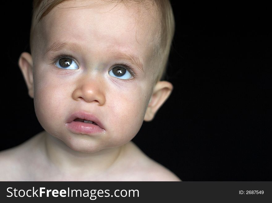 Image of beautiful toddler with a serious look on his face