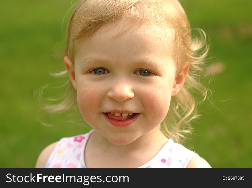 A pretty little girl (almost 3 years old) outside in a flowered dress. A pretty little girl (almost 3 years old) outside in a flowered dress