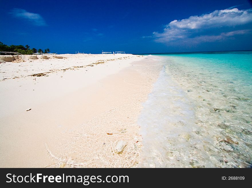 Ocean view of beautiful caribbean blue water beside a secluded white sand beach. Ocean view of beautiful caribbean blue water beside a secluded white sand beach