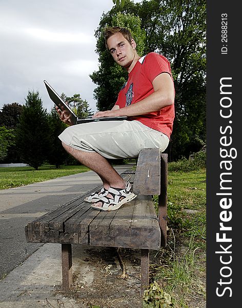 Picture of young man with notebook in park