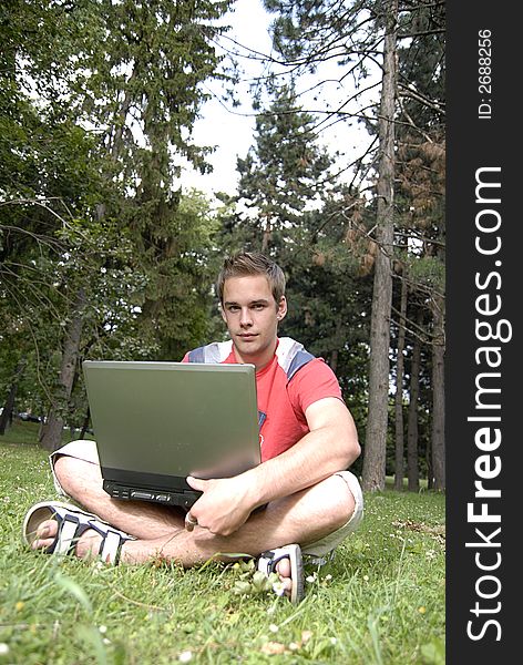 Picture of young man with notebook in park