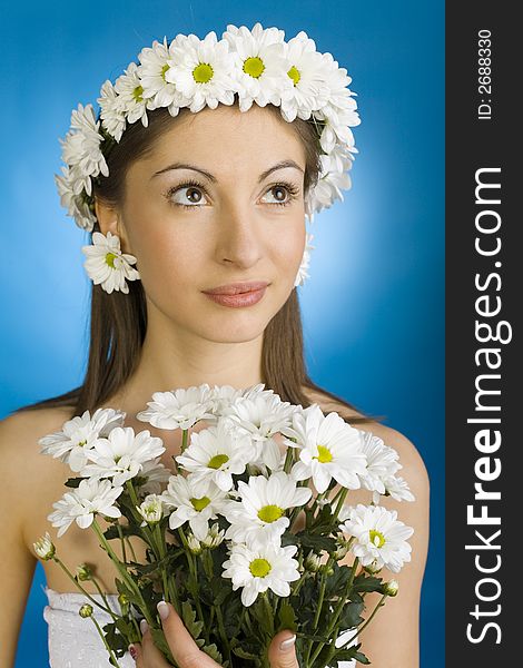 Young, beautiful woman with bouquet of white flowers. Blue background. Young, beautiful woman with bouquet of white flowers. Blue background