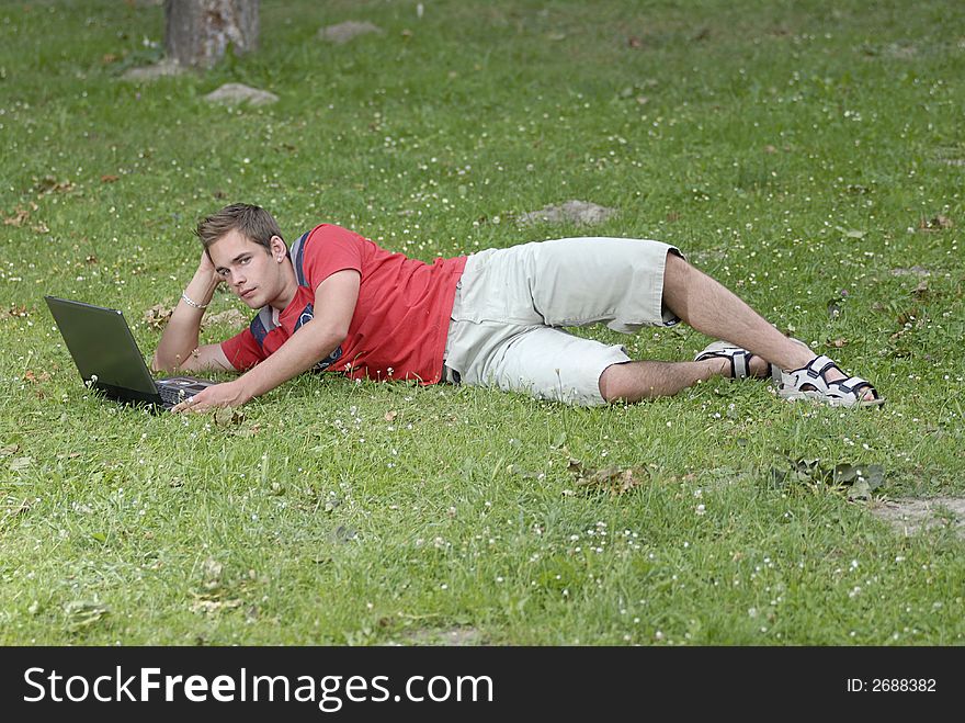 Picture of young man with notebook in park