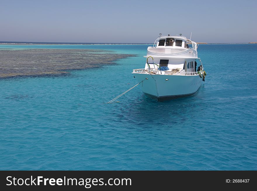 The ship standing in the sea near coral a reef. The ship standing in the sea near coral a reef