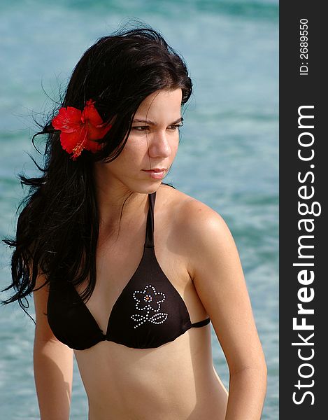 Young tropical girl portrait wearing bikini on beach background. Young tropical girl portrait wearing bikini on beach background