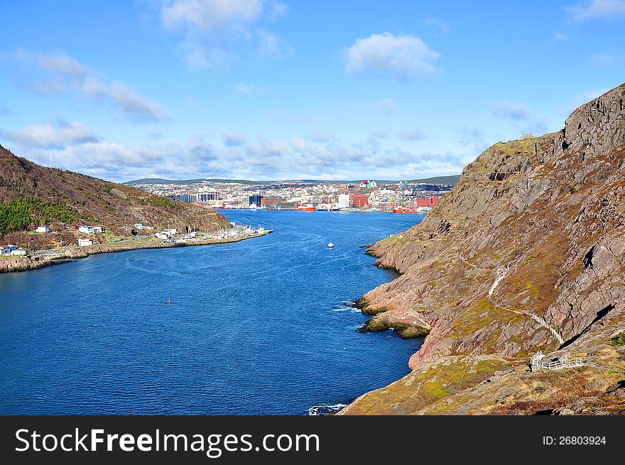 Dramatic wide angel view of the entrance leading into St Johns Harbour in the province of Newfoundland in Canada. Towering cliffs of over 450 feet on each side lead ships of all types into the inner harbour. Dramatic wide angel view of the entrance leading into St Johns Harbour in the province of Newfoundland in Canada. Towering cliffs of over 450 feet on each side lead ships of all types into the inner harbour.