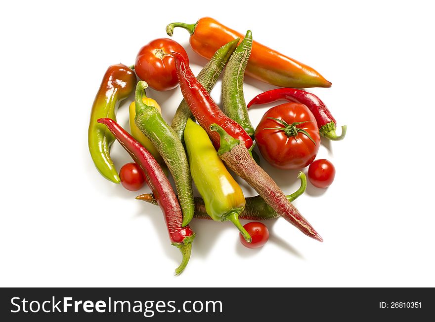 Homemade peppers and tomatoes on white background. Homemade peppers and tomatoes on white background