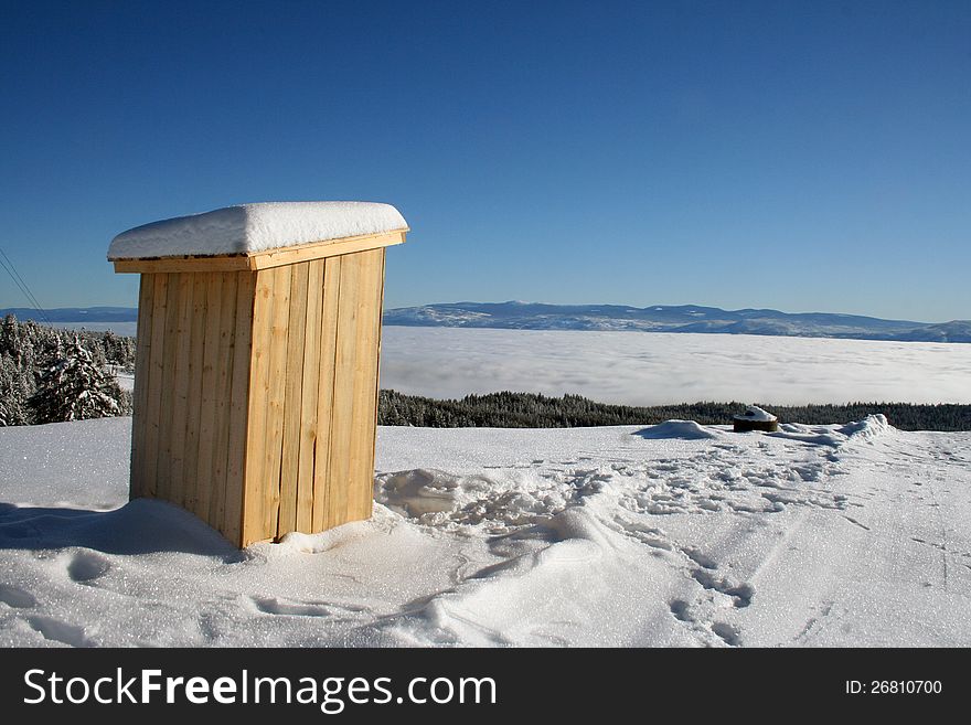 Wooden cabin at the top of the snowie mountain