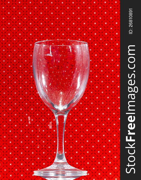 Close up view of transparent glass over a red background. Close up view of transparent glass over a red background.