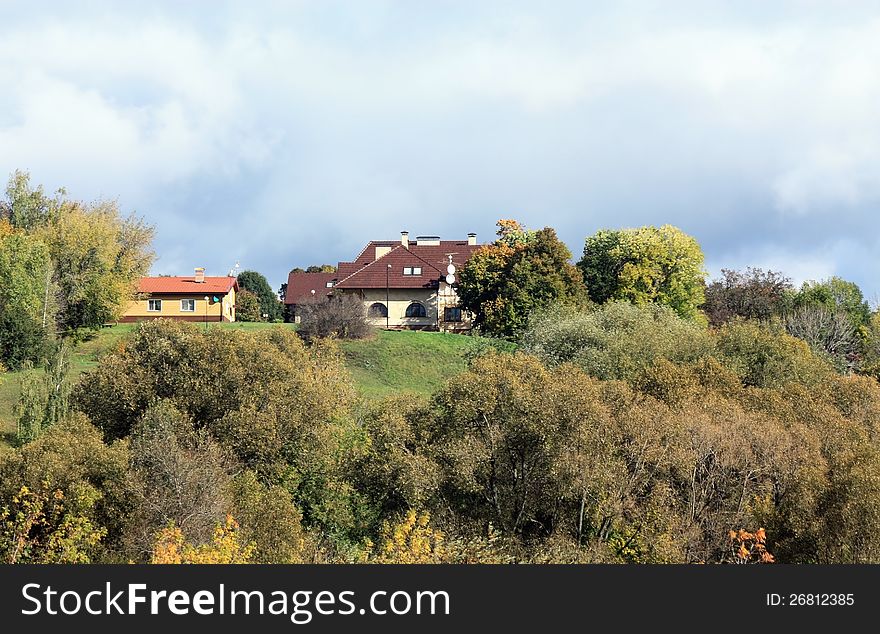 Two residential houses among trees on the hillside. Two residential houses among trees on the hillside