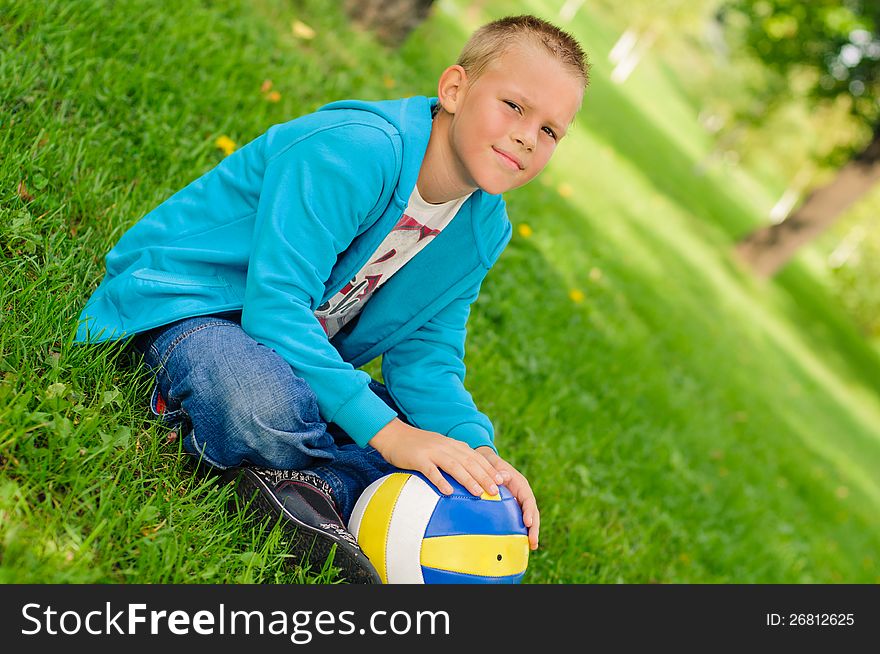 Young Boy Sitting Outdoors