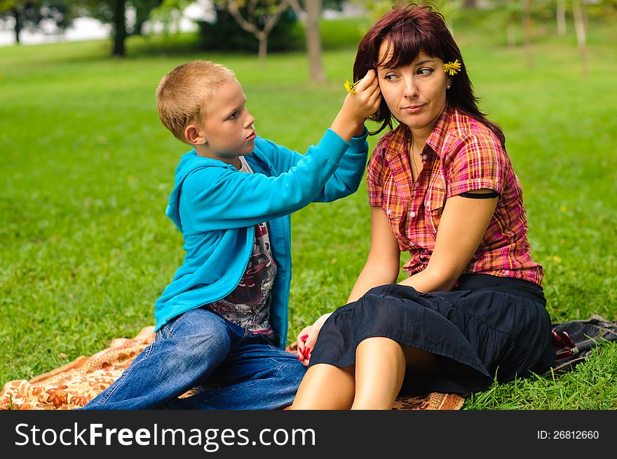 Mother and son play outside on field in the park. Mother and son play outside on field in the park