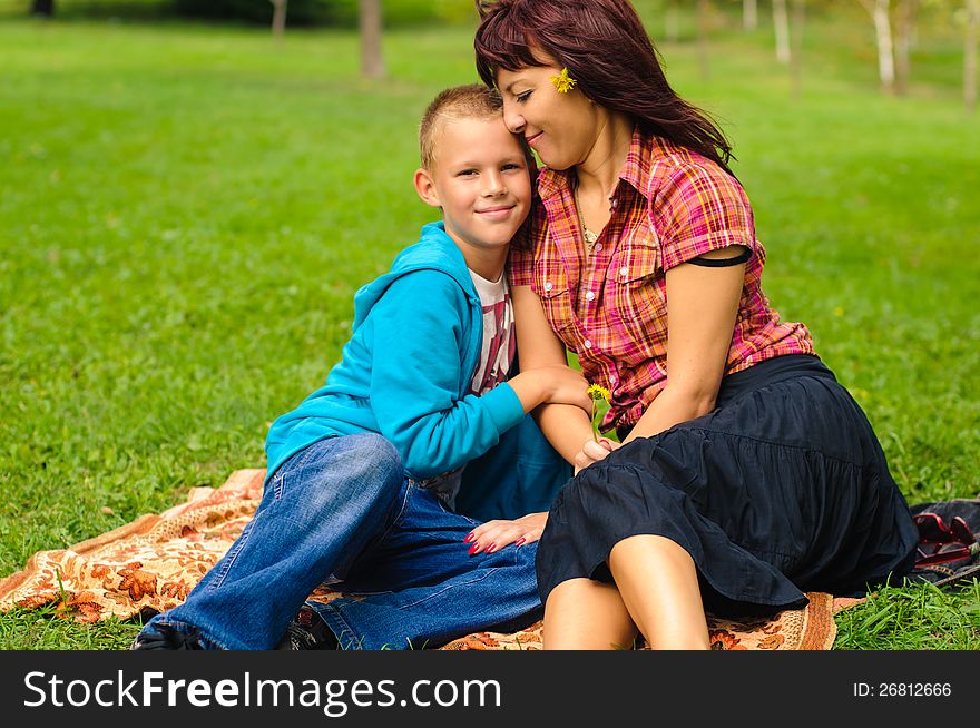 Mother and son play outside on field in the park. Mother and son play outside on field in the park