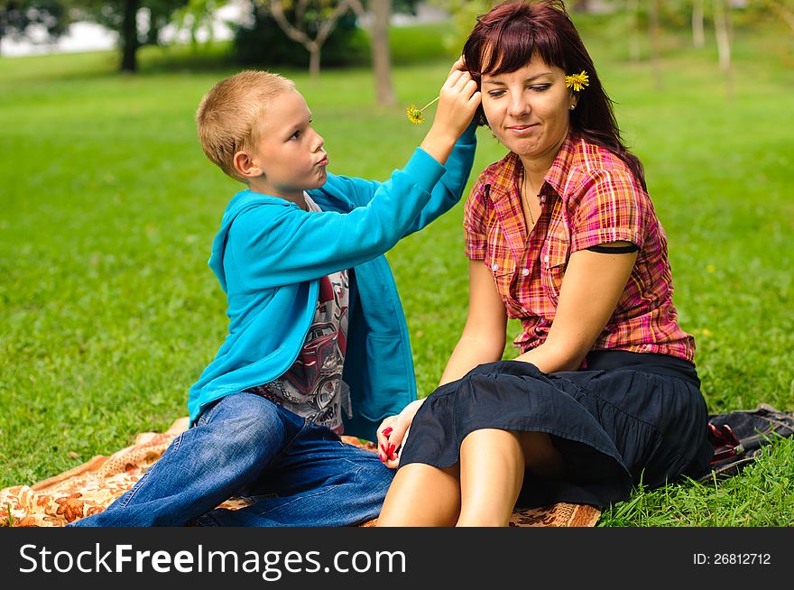 Mother and son play outside on field in the park. Mother and son play outside on field in the park