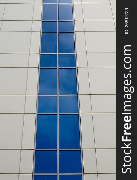Blue sky reflected in the windows of office building. Blue sky reflected in the windows of office building