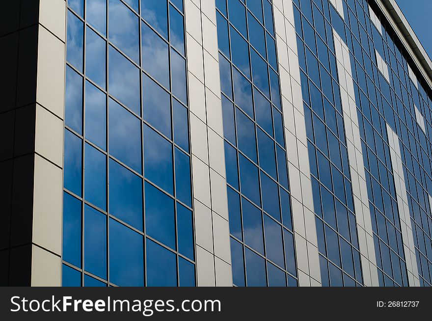 Blue sky reflected in the windows of office building. Blue sky reflected in the windows of office building