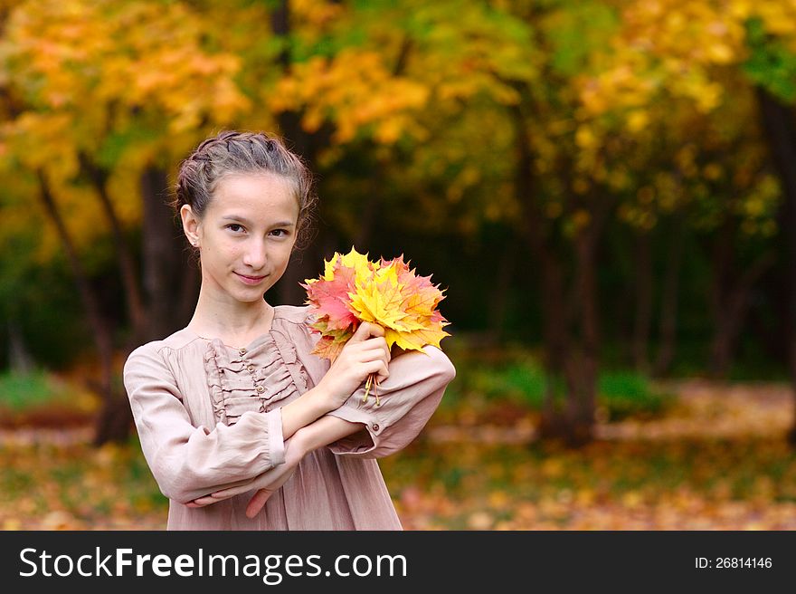 Portrait Of Girl With Maple Leaves