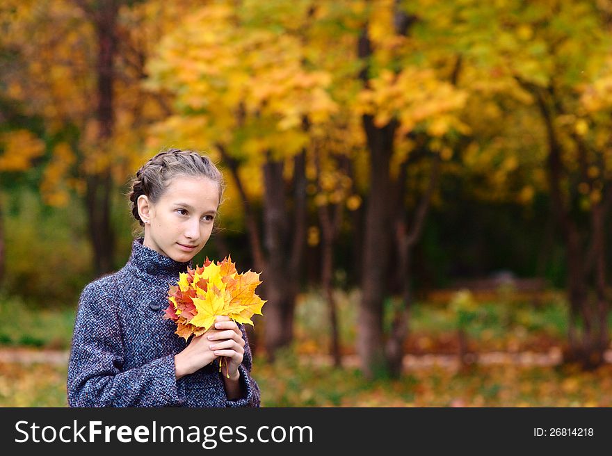 Portrait of Girl in the park with maple leaves. Portrait of Girl in the park with maple leaves