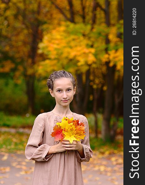 Portrait of Girl in the park with maple leaves. Portrait of Girl in the park with maple leaves