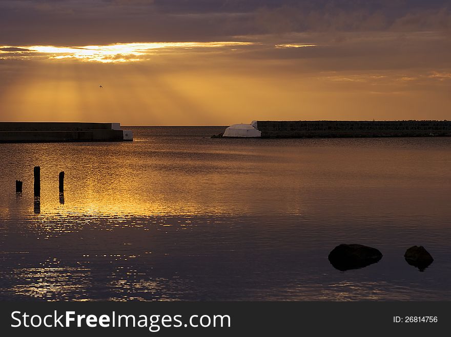 Beautiful sunrise In Kivik, golden sky and calm water. Beautiful sunrise In Kivik, golden sky and calm water