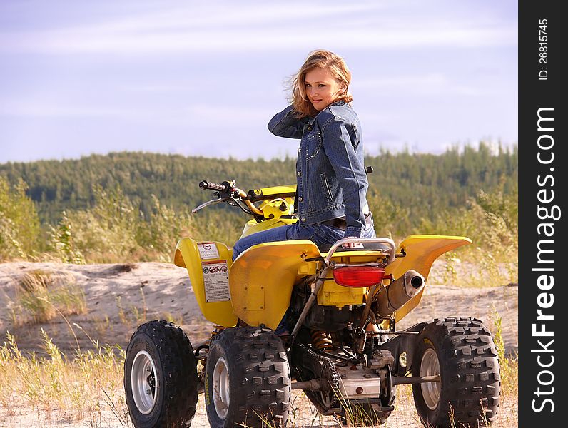 Beautiful blonde on sport quadrocycle on background of the nature. Beautiful blonde on sport quadrocycle on background of the nature.