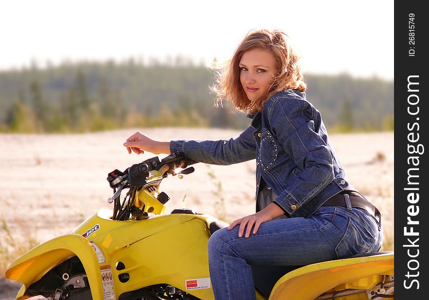Beautiful blonde on sport quadrocycle on background of the nature. Beautiful blonde on sport quadrocycle on background of the nature.