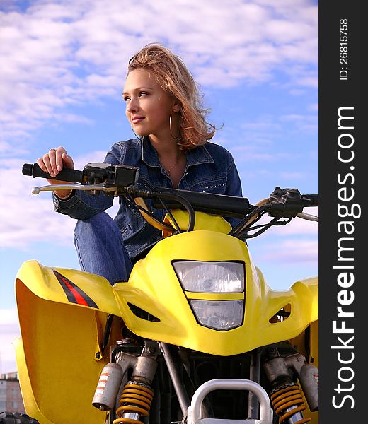 Beautiful blonde on sport quadrocycle on background of the blue sky. Beautiful blonde on sport quadrocycle on background of the blue sky.