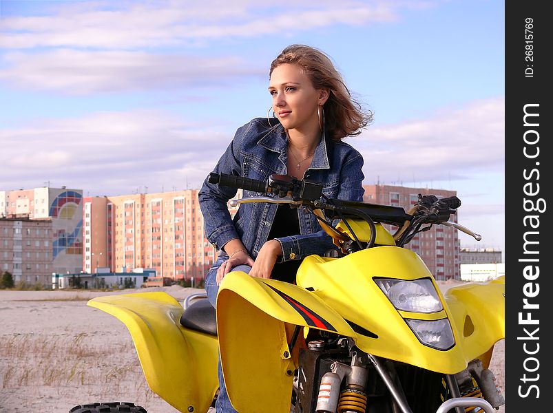 Beautiful blonde on sport quadrocycle on background of the city Nadym. Beautiful blonde on sport quadrocycle on background of the city Nadym.