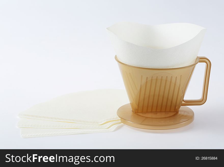 Three holes type coffee dripper with filter isolated on white