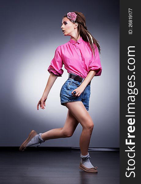 Fashion Girl In Denim Shorts Running In Studio