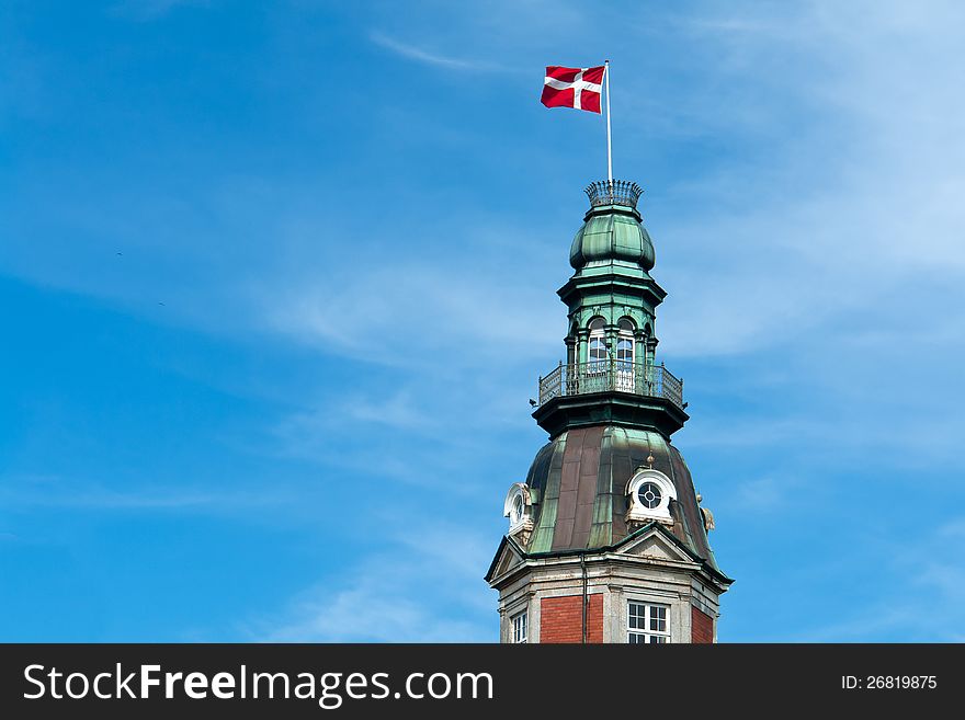 Flag of Denmark up high in the air with blue sky horizontal background