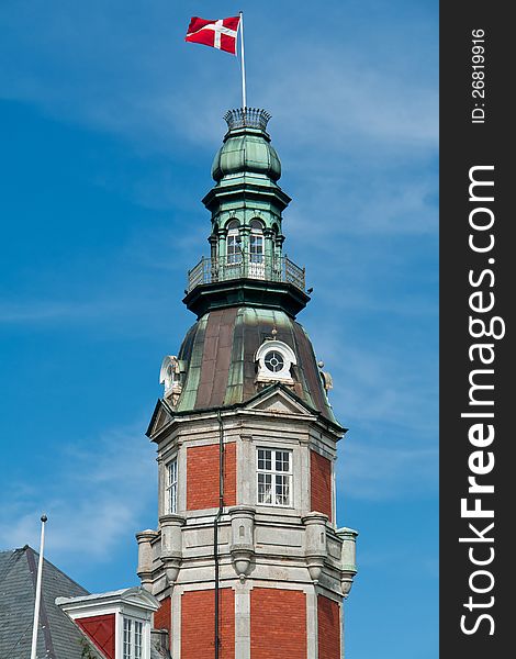 Flag of Denmark up high in the air with blue sky vertical background