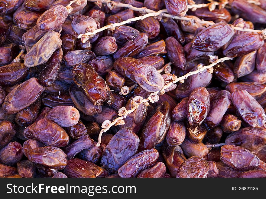 Close view of a bunch of dried date fruits on a table.