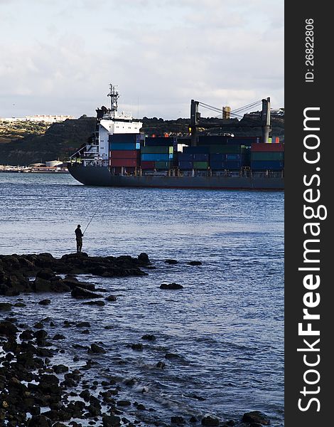 View of a huge container ship leaving the city.