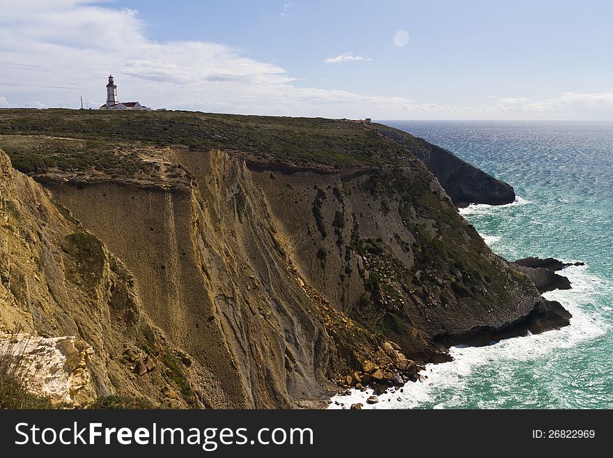 View of the beautiful lighthouse of Cape Espichel, Sesimbra, Portugal.