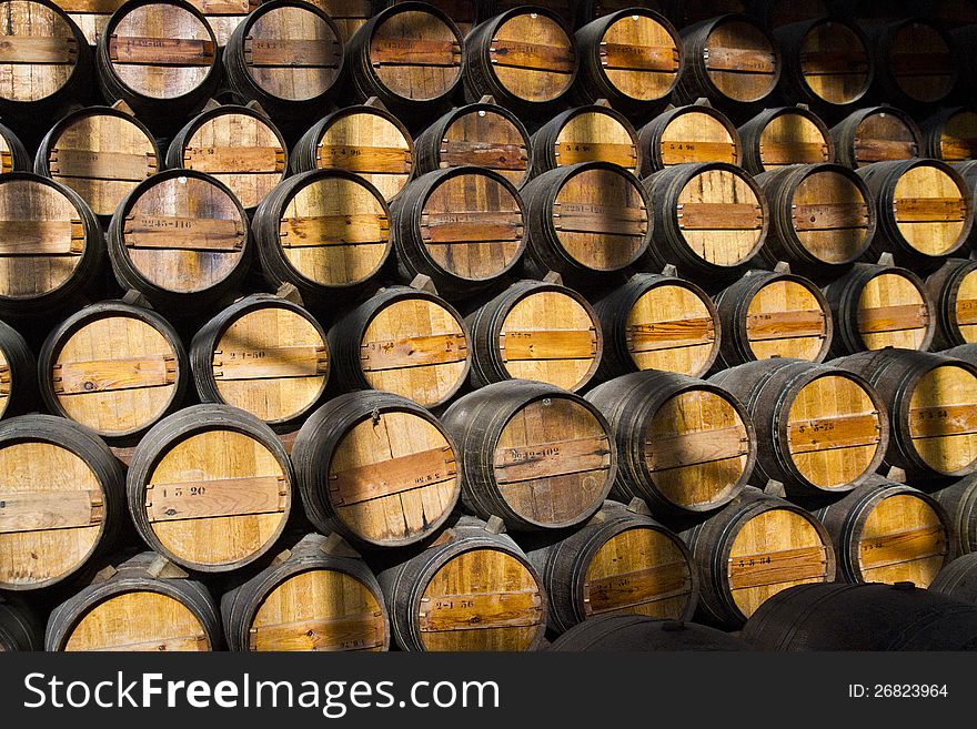 View of a bunch of wooden wine barrels on a cellar.