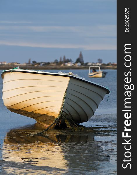 Beautiful view of sunrise with a beach and small fishing boats near Olhao, Portugal. Beautiful view of sunrise with a beach and small fishing boats near Olhao, Portugal.