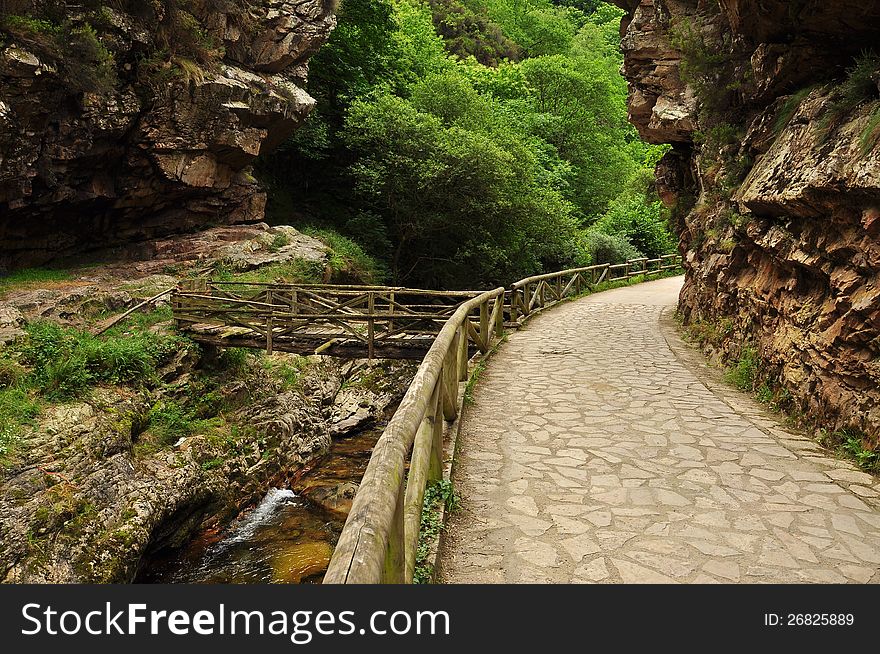 Mountain hiking trail - path in the gorges near Soto de Agues, Sobrescobio, Asturias, Spain. Mountain hiking trail - path in the gorges near Soto de Agues, Sobrescobio, Asturias, Spain