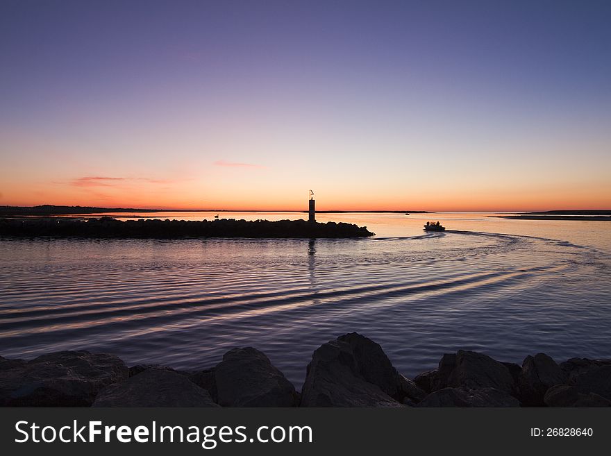 Beautiful view of the departure of a fishing boat in the early morning in Fuzeta, Portugal. Beautiful view of the departure of a fishing boat in the early morning in Fuzeta, Portugal.