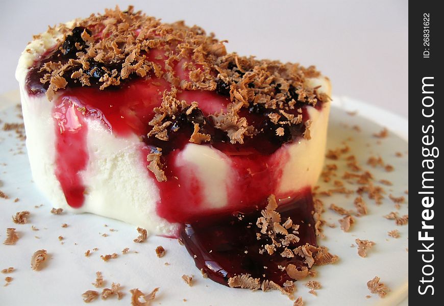 Vanilla ice cream with currant syrup and grated chocolate