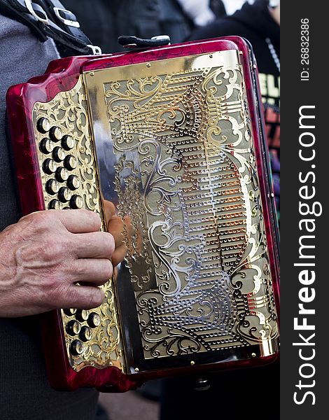 Close view of an musician playing a beautiful accordion instrument. Close view of an musician playing a beautiful accordion instrument.