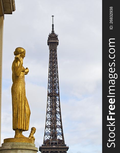 View of a beautiful gold statue of the Chaillot palace in Paris, France, in with Eiffel tower on the background. View of a beautiful gold statue of the Chaillot palace in Paris, France, in with Eiffel tower on the background.