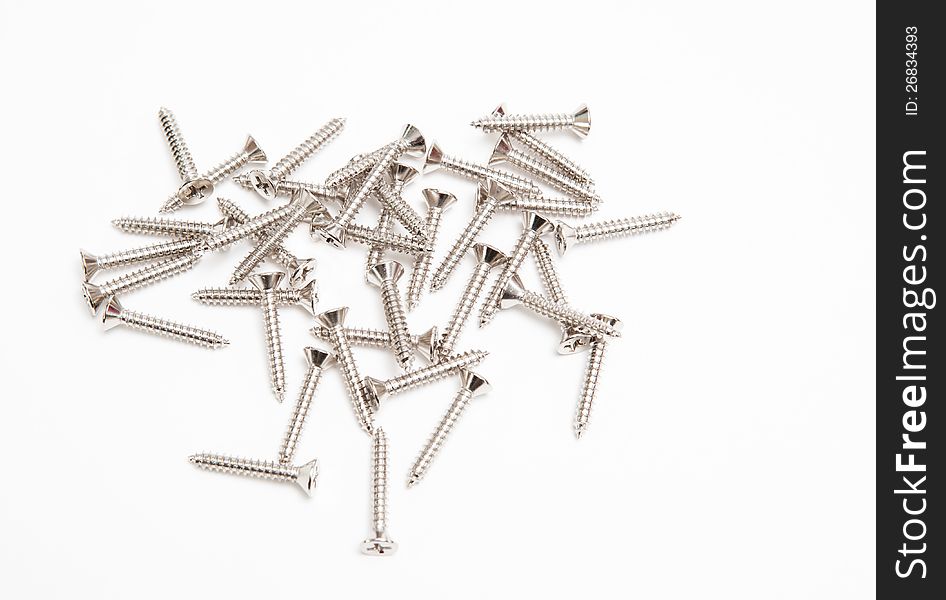 Heap of screws on white background