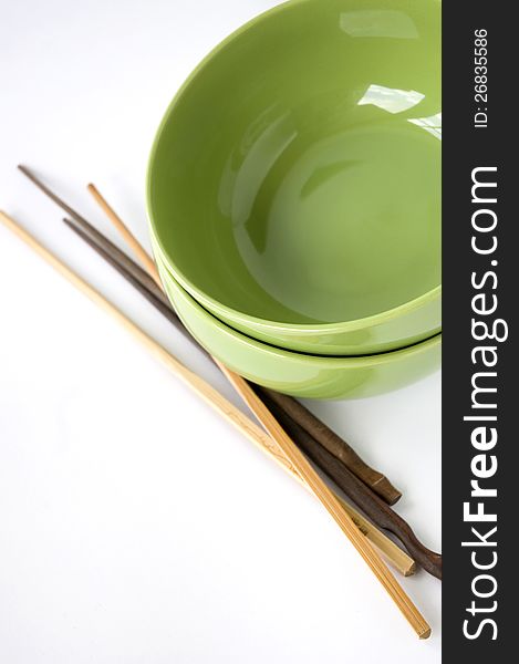 Green bowl and chopstick on white background