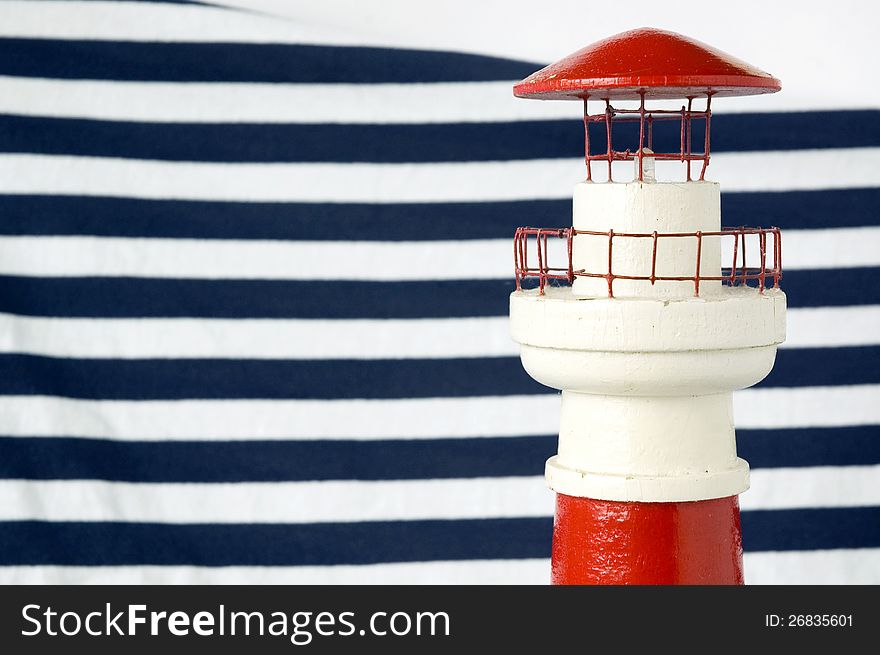 Red lighthouse model with blue strips background. Red lighthouse model with blue strips background