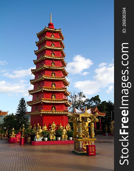 Red Chinese tower in monastery outside against the sky. Monastery of ten thousand Buddhas in Gonkong, China.