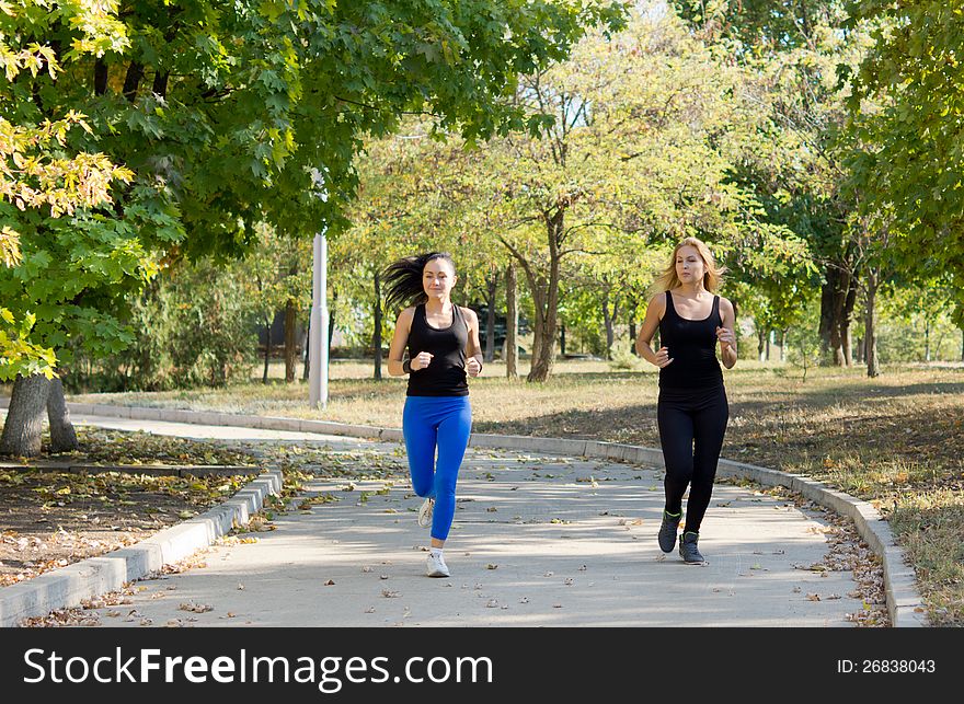 Two women jogging in a park