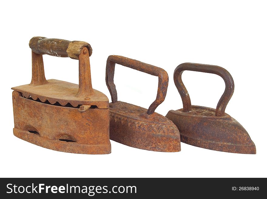 Three old metal iron on a white background. Three old metal iron on a white background