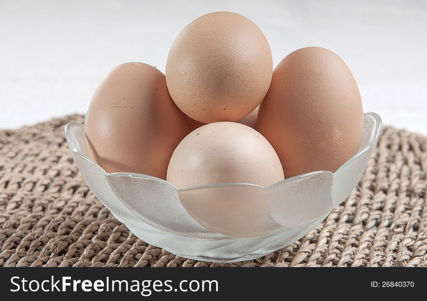 Eggs in glass bowl  on the table