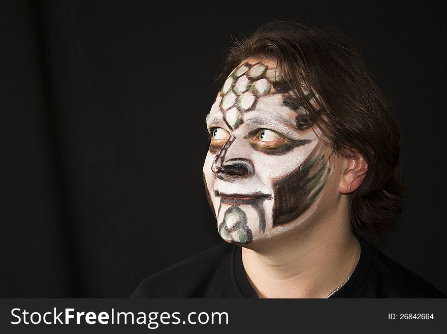 Make-up of a dragon on a man s face